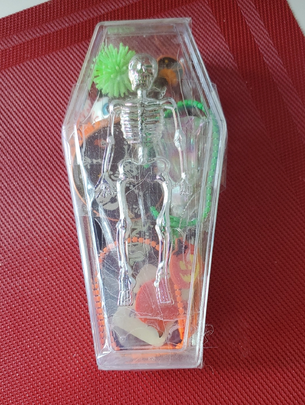 Clear Coffin Display with Silver Skeleton and Neon Accents